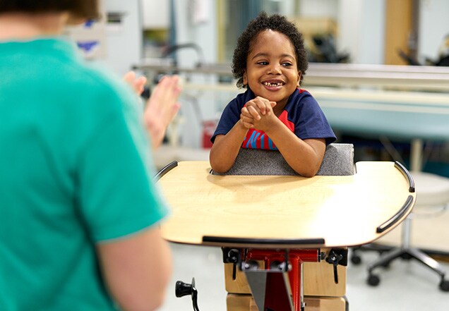 Child with doctor receiving physical therapy