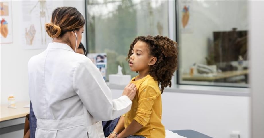 Doctor listening to Child's heart palpitations