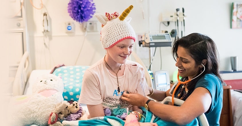 Keren Clay smiling in hospital with oncologist