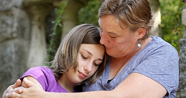 Mom holding and comforting daughter