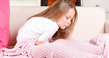 Child holding upset stomach