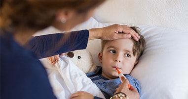 Boy getting his temperature checked