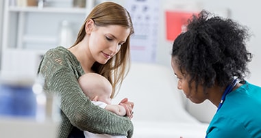 Nurse giving an infant boy the flu shot
