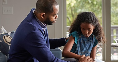 dad consoling sad daughter