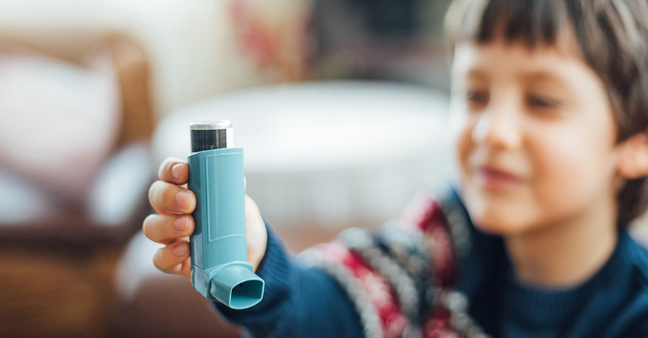 Boy learns how to use asthma inhaler