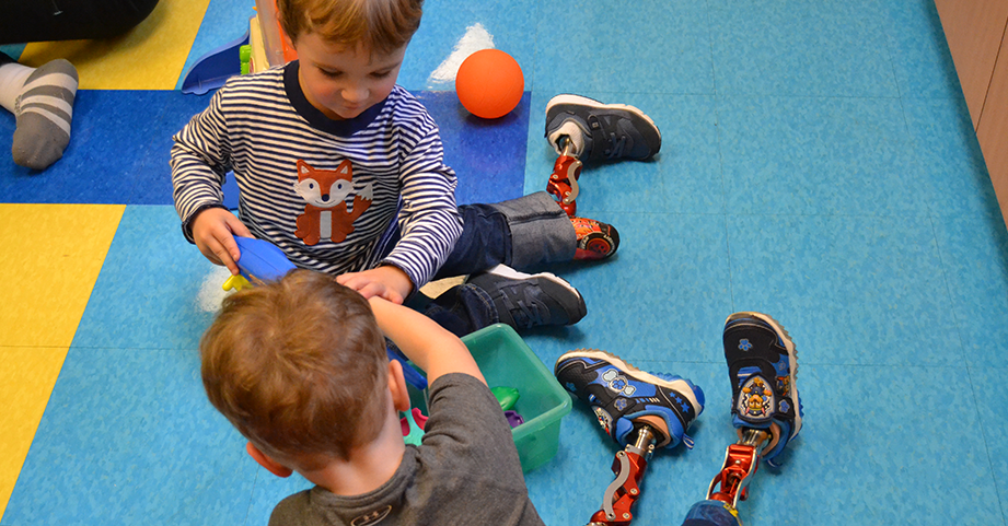 Children with prosthetic legs playing together