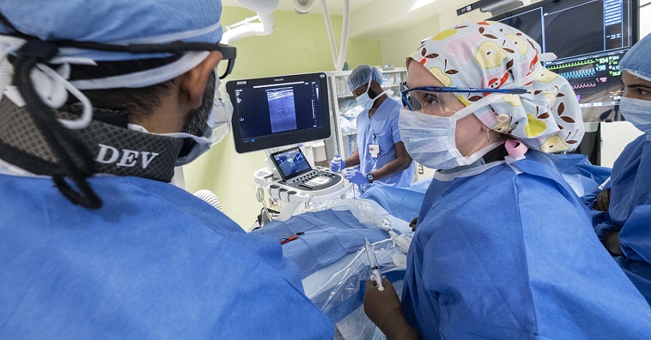 Interventional radiologists performing procedure.