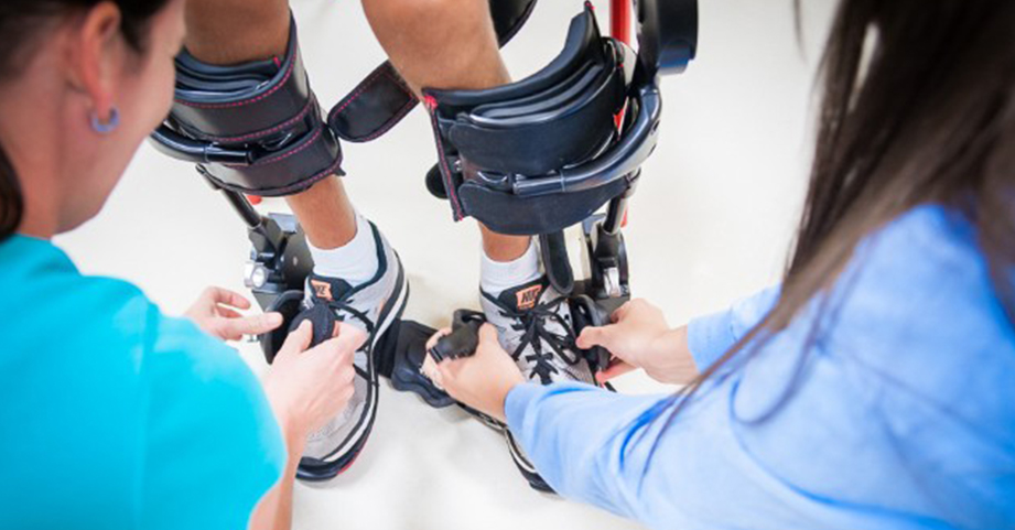 rehab ekso robotic exoskeleton strapping in feet