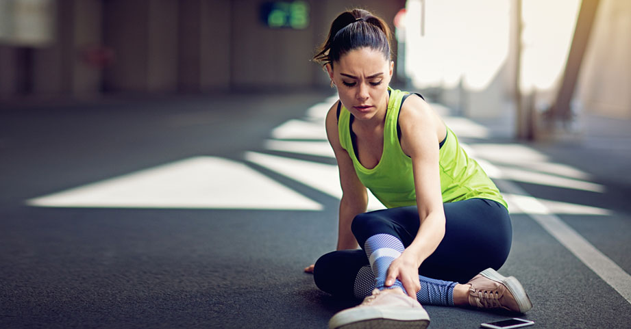 Teen girl runner grabbing leg because of muscle cramp