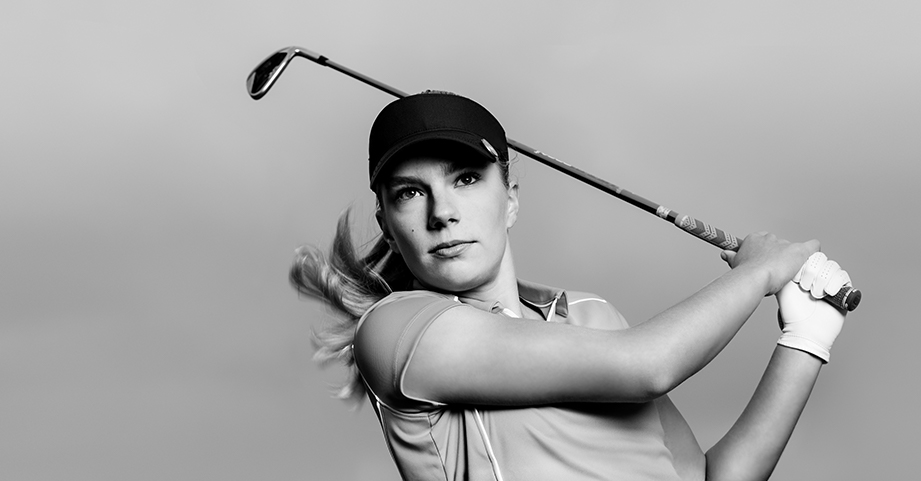 Female golfer swinging a golf club