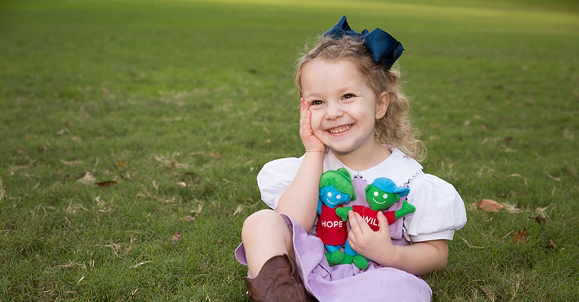 Pediatric brain cancer patient smiling with hope and will
