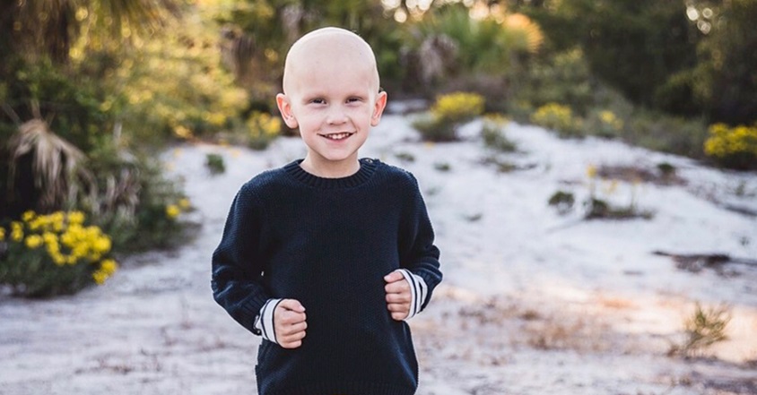 Boy with pediatric brain tumor smiling