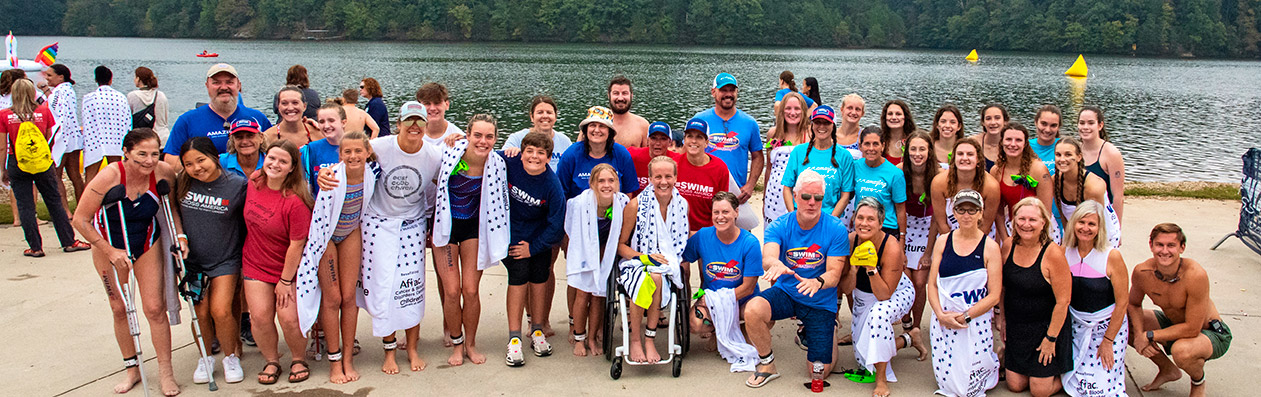 Group of Swim Across America participants by lake