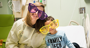 nurse and pediatric patient smile with funny glasses