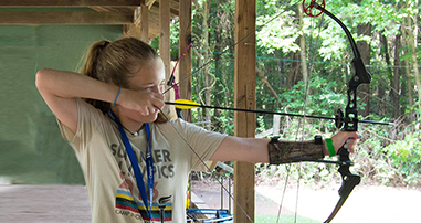 Girl shooting archery at Camp Independence