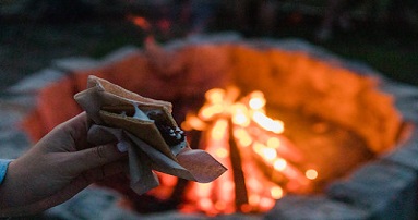 Person holding smores near fire