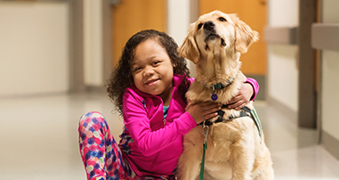 girl patient with dog in hallway of Children's Healthcare of Atlanta