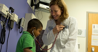 Dr. Vos examining little boy in clinic