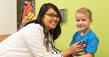 Allergy doctor listening to child's heart