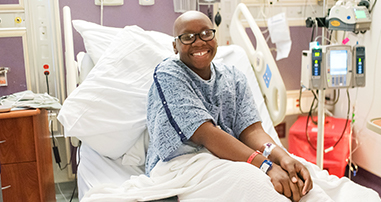 bmt patient smiling in hospital bed