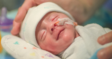 Newborn baby in neonatal intensive care unit