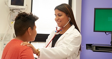 Dr. Soler Rodriguez examining teen boy