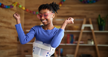 Teen girl with a scoliosis brace dancing 