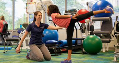 Pediatric sports physical therapist assists teen dancer 