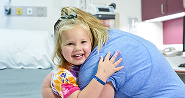 pediatric patient girl hugging mom in hospital