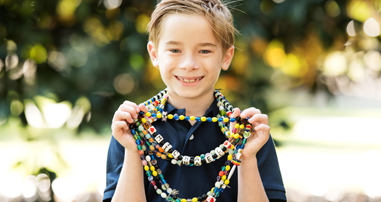 Michael Henderson holding a bead necklace