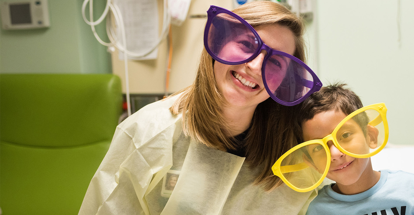 Nurse and pediatric patient smile with funny glasses
