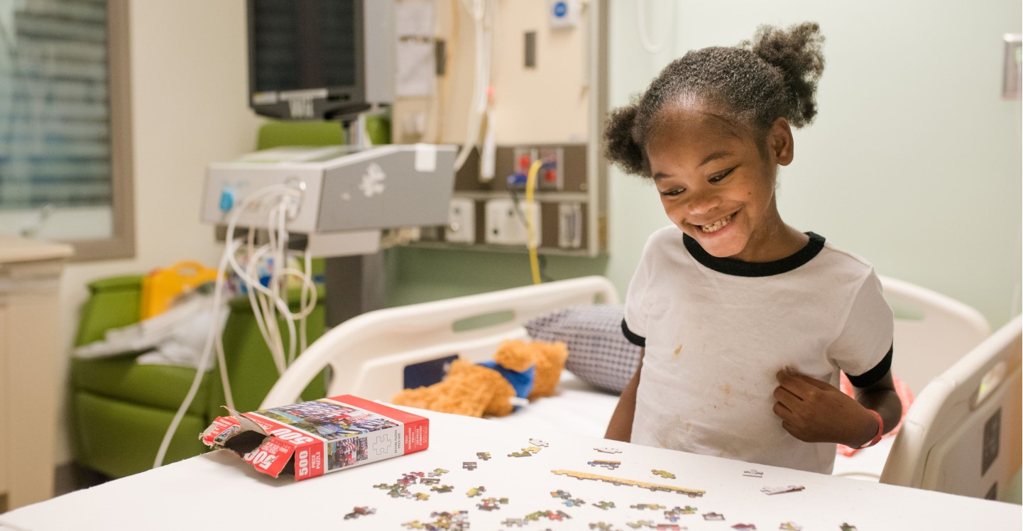 Patient playing with a puzzle in pediatric hospital room