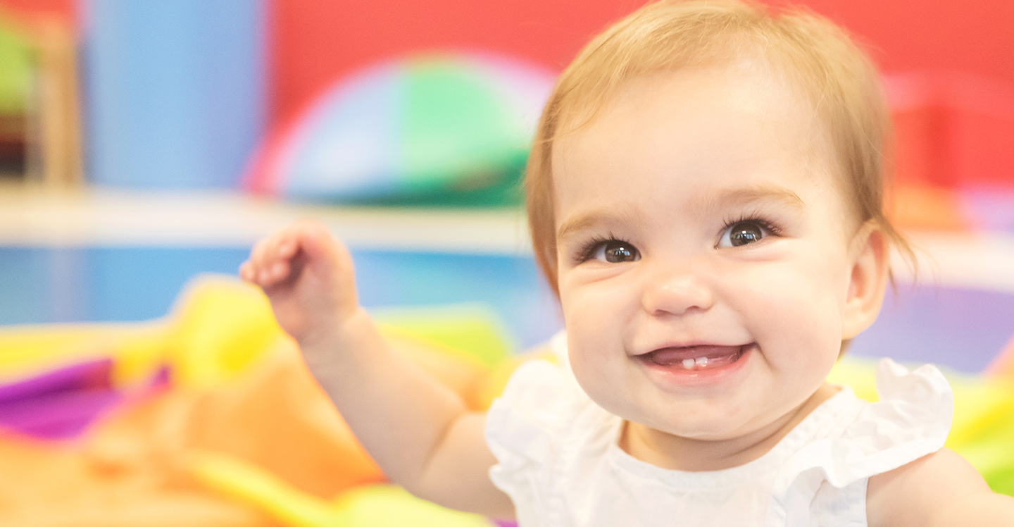 Baby girl smiling in preschool