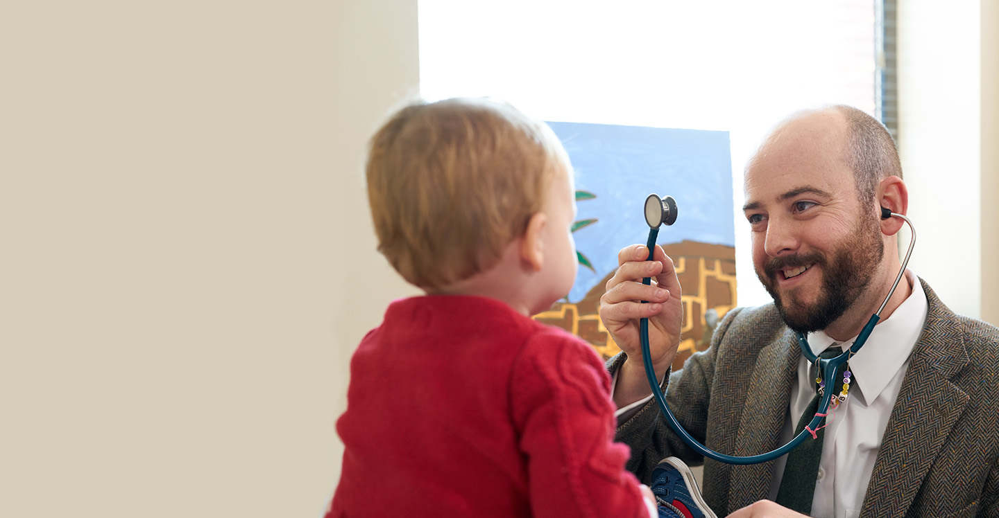 Dr. David O’Banion examining little boy at Marcus Autism Center