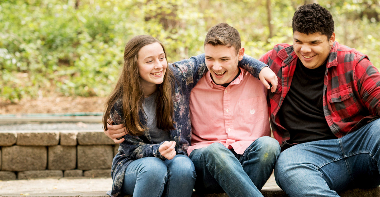 three teens laughing outside