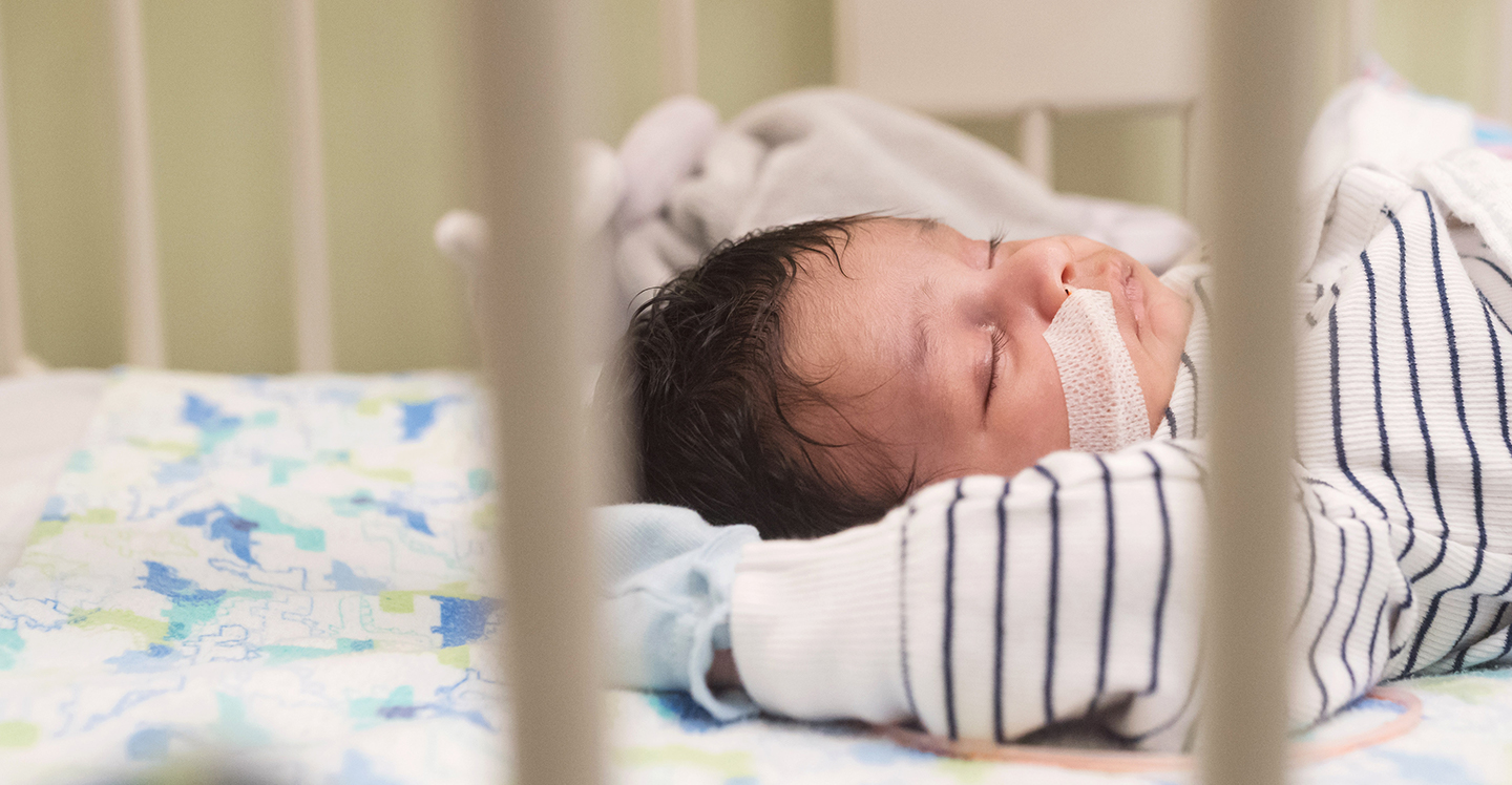 pediatric critical care patient asleep in hospital crib