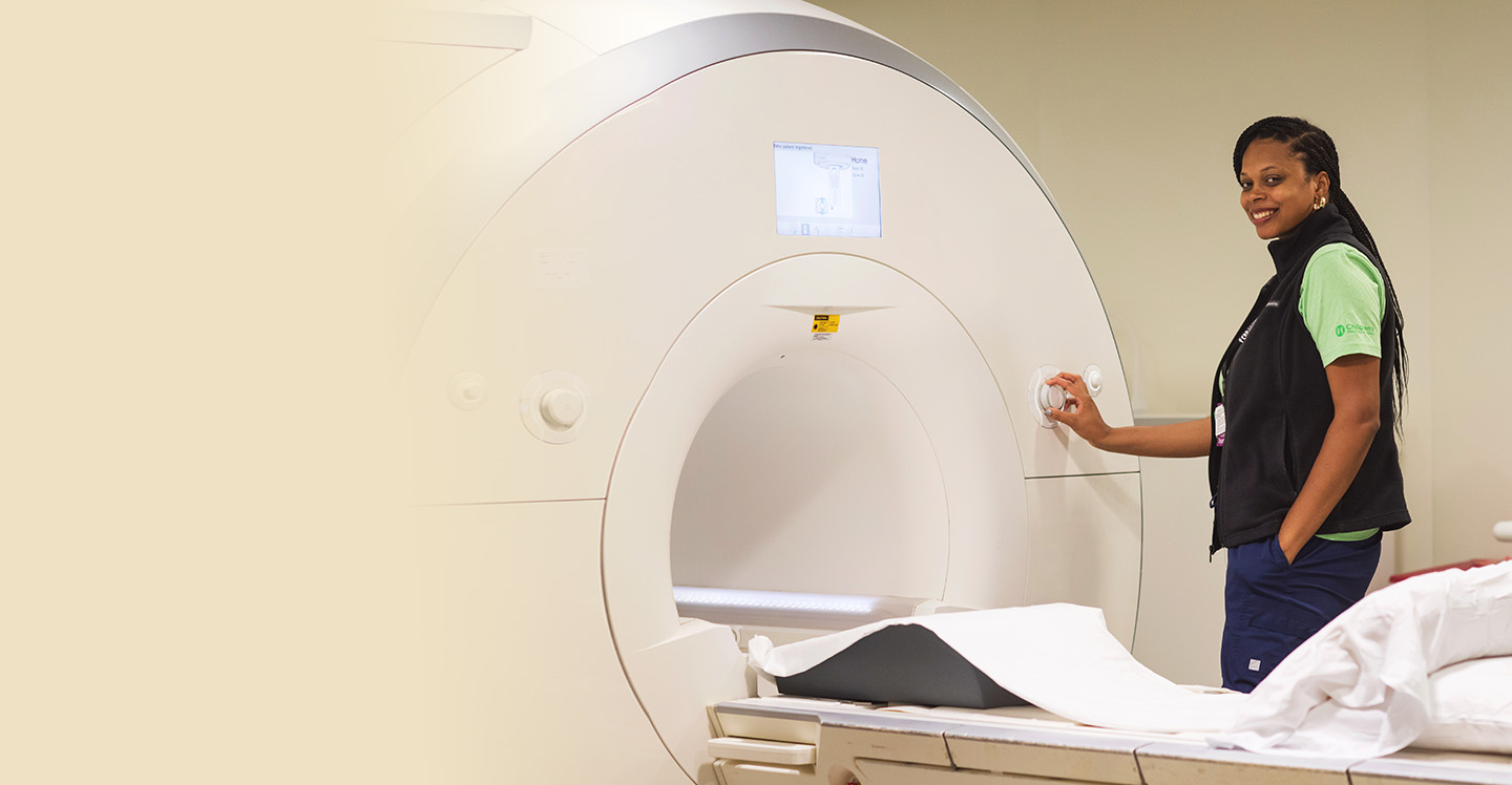 Pediatric radiology team member prepares MRI machine.