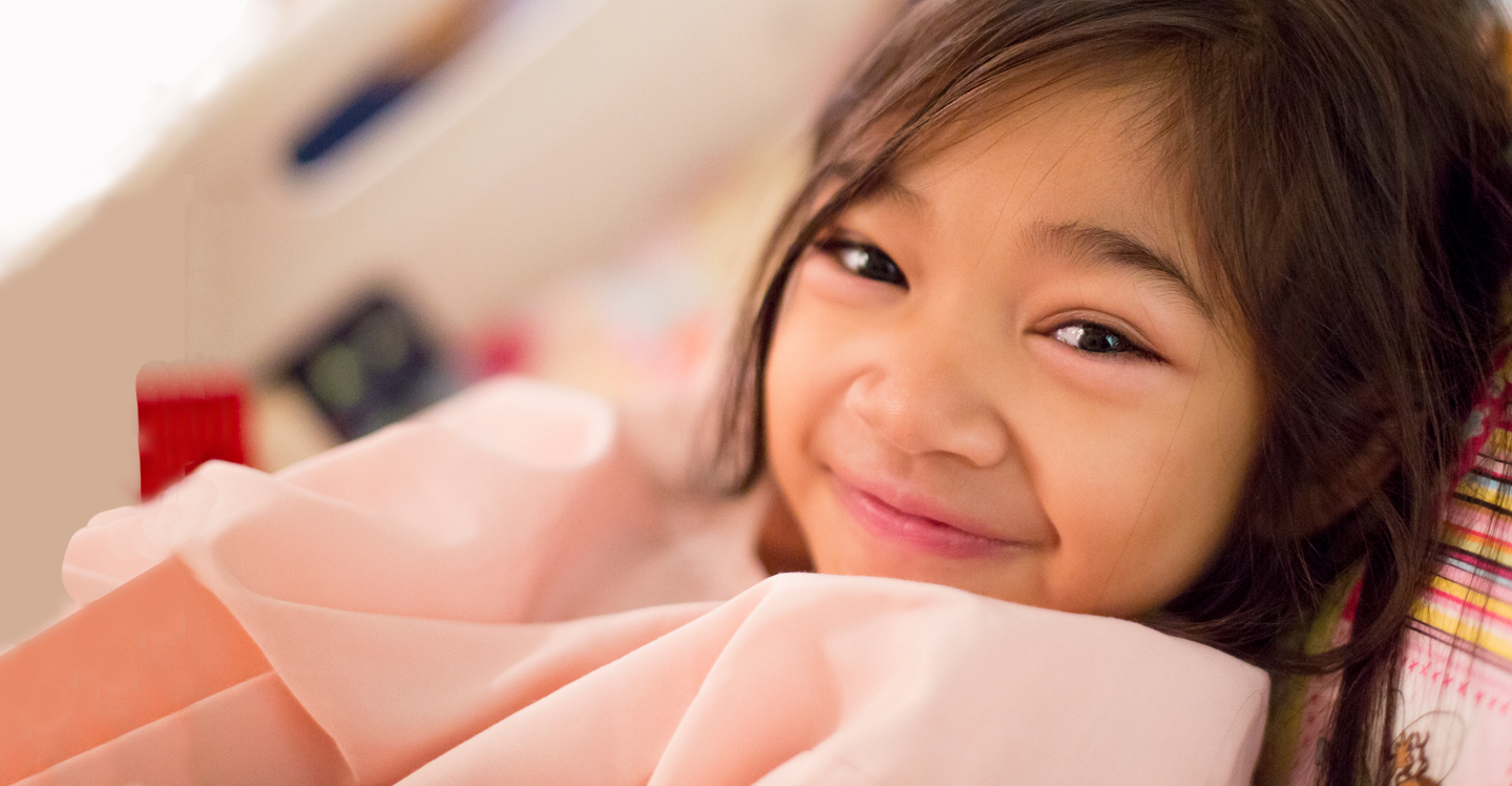 girl smiling in hospital bed