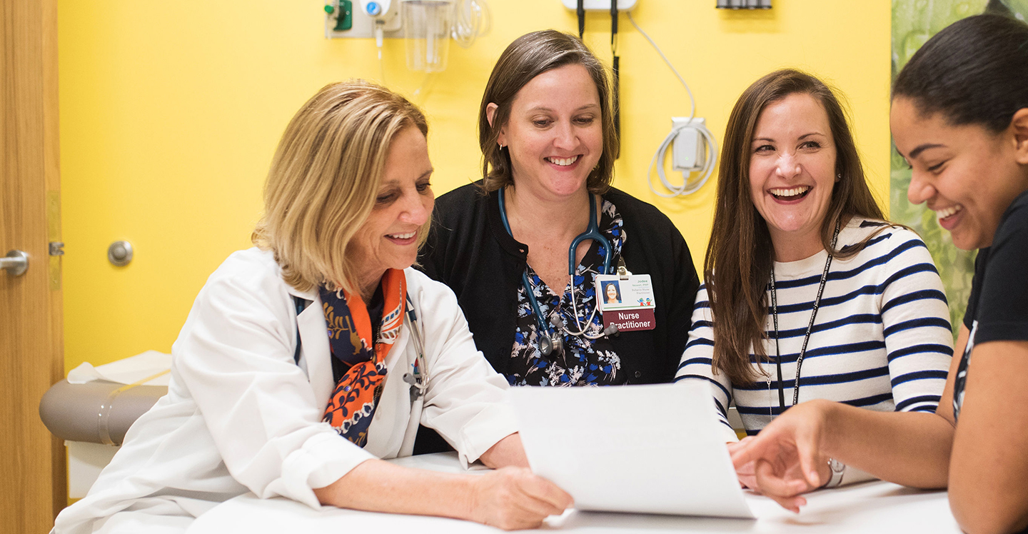 pediatric hospital staff smiling and working together