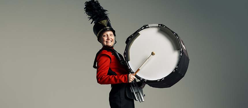 pediatric cancer patient girl playing drums in high school marching band