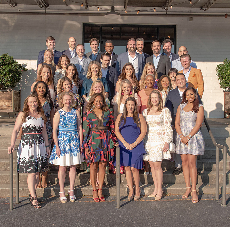 leadership group of men and women smiling at a fundraising event