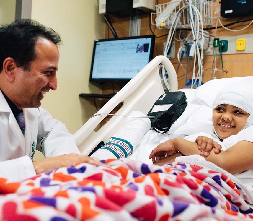 pediatric neurology doctor visiting his patient in her hospital room