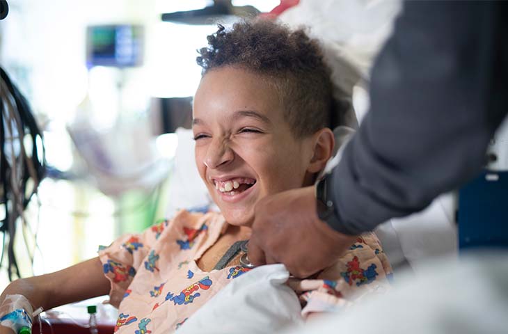 Pediatric heart patient laughing in hospital