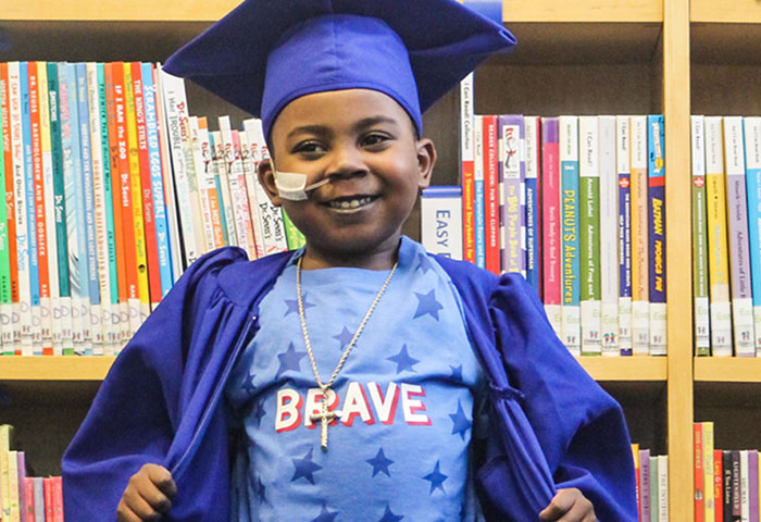 boy graduating after receiving pediatric heart transplant