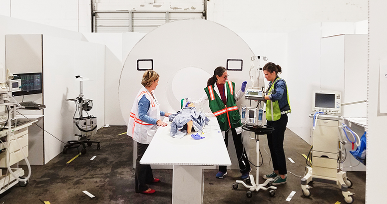 radiology and sedation staff run through MRI simulation in cardboard city