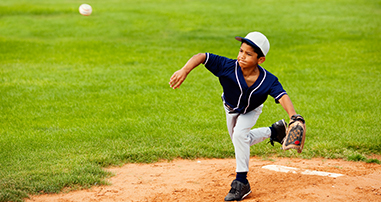 little league player pitching